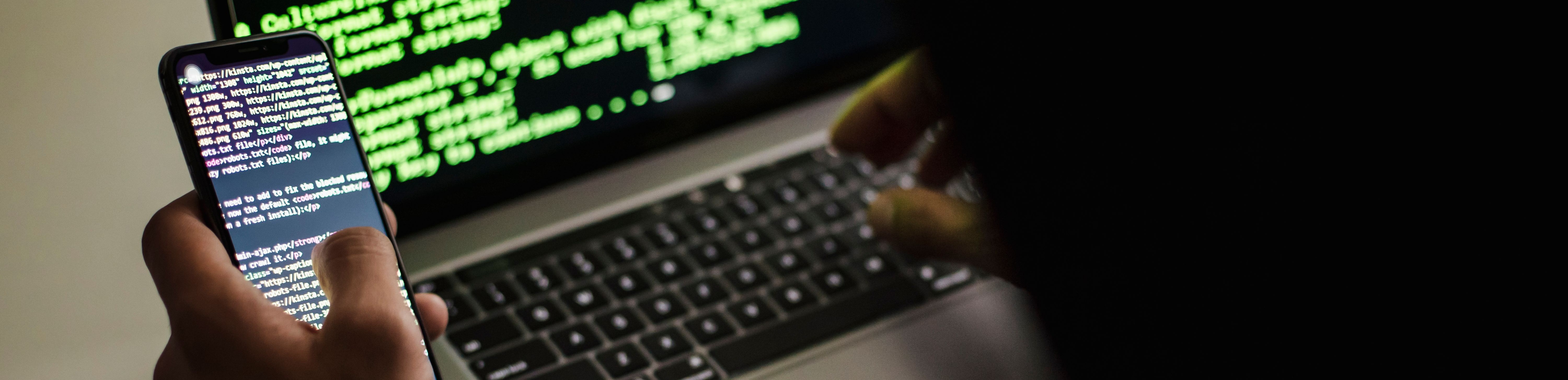 A person using a laptop with code on it